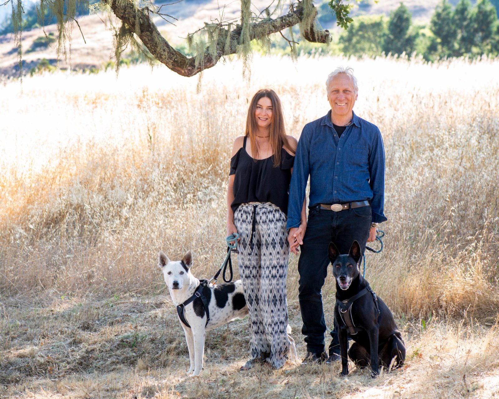 Larry Bragman and Holly outdoors with their dogs